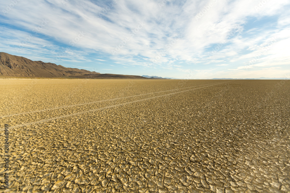 Naklejka premium Tire tracks running across the black rock desert playa