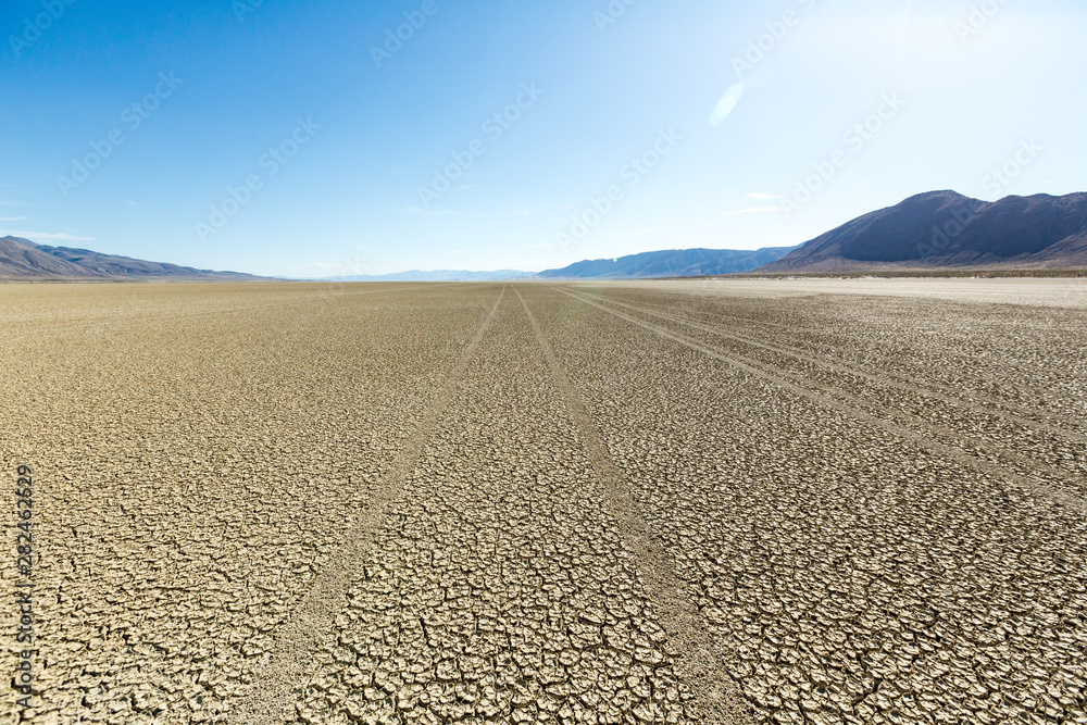 Naklejka premium Tire tracks running across the black rock desert playa