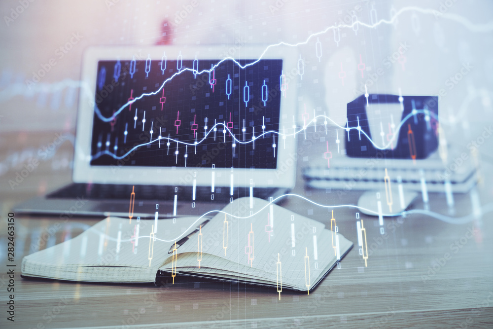 Forex market chart hologram and personal computer background. Double exposure. Concept of investment. Forex market chart hologram and personal computer background. Double exposure. Concept of investment.