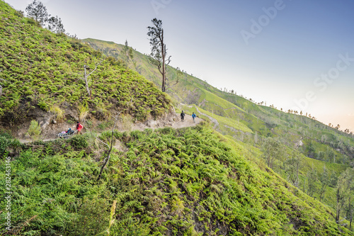 The magnificent views on green mountains from a mountain road trecking to the Ijen volcano or Kawah Ijen on the Indonesian language. Famous volcano containing the biggest in the world acid lake and photo