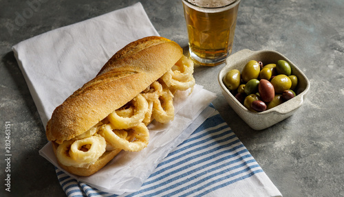 Konstfotografi bocadillo con calamares or squid sandwich with beer, very popular in Madrid span