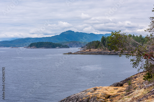 View over Inlet, ocean and island with boat and mountains in beautiful British Columbia. Canada.