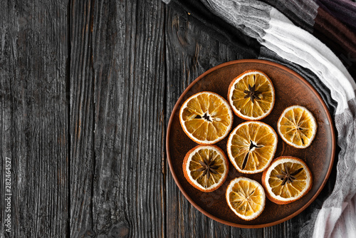 Christmas - natural Christmas decorations on a plate - dried oranges and anise