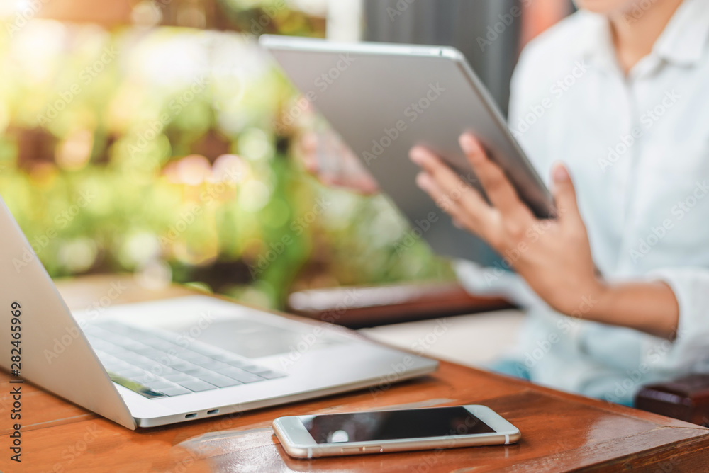 Female coworker using laptop while sitting at modern workspace and drinking coffee to go, businesswoman work process concept. Female coworker using laptop while sitting at modern workspace and drinking coffee to go, businesswoman work process concept.