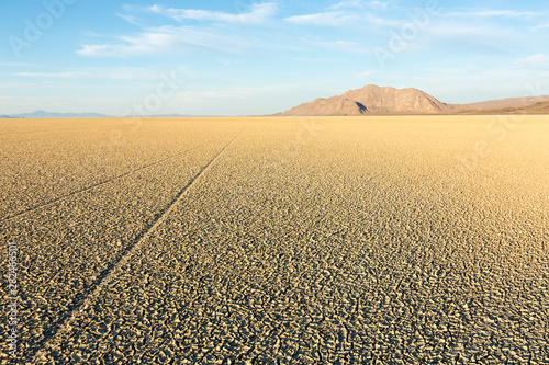 Tire tracks running across the black rock desert playa © ecummings00