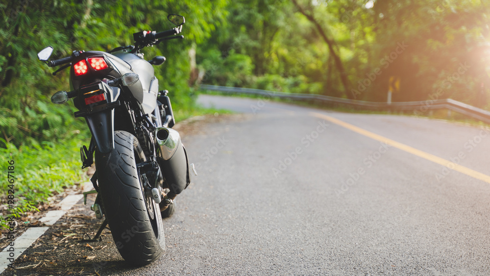 Obraz premium motorcycle in a sunny motorbike on the road riding.with sunset light. copyspace for your individual text. 