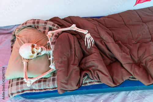 Skeleton relaxing in a tent while camping
