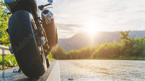 Fototapeta Naklejka Na Ścianę i Meble -  motorcycle in a sunny motorbike on the road riding.with sunset light. copyspace for your individual text. 