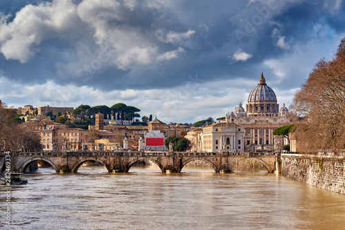 St. Peter's cathedral and Tiber river with high water in February. Saint Peter Basilica in Vatican city with Saint Angelo Bridge in Rome, Italy © haveseen