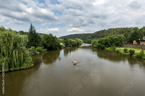 panorama of river Sazava with green shores and sailing canoe downstream