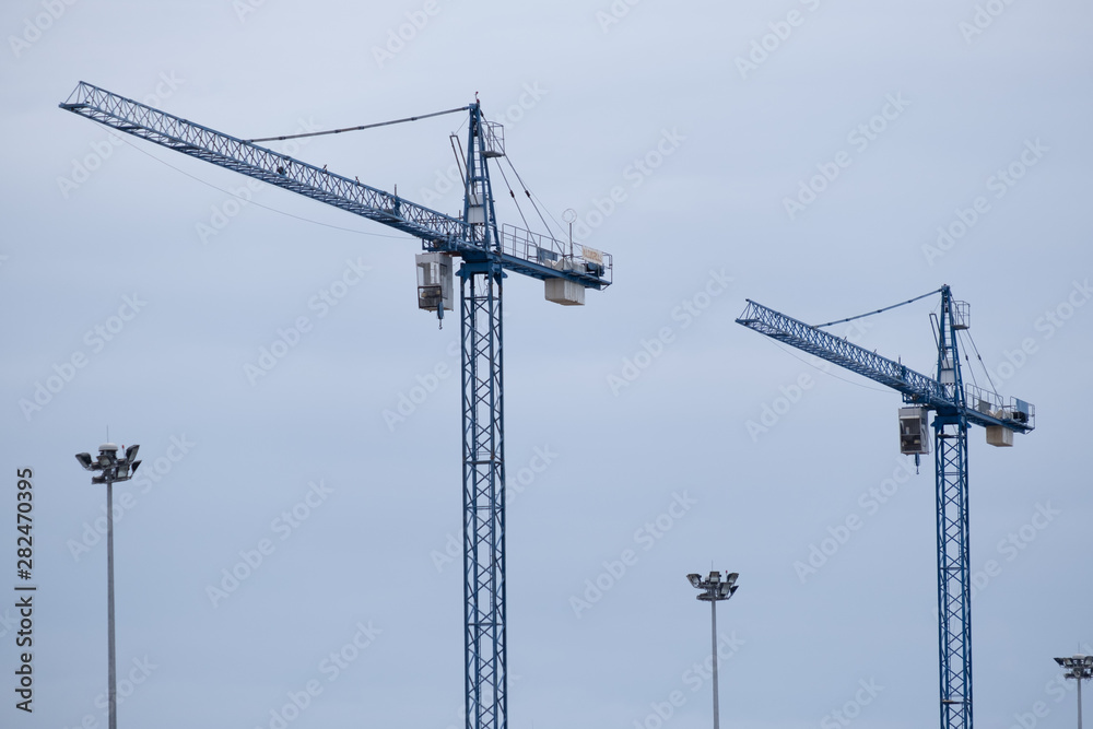 Twin cranes at construction site