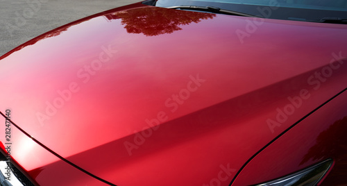 Close up of red metallic paint coating car body photo