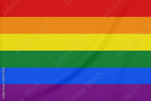 Rainbow LGBT pride flag on a textured fabric. Pride symbol