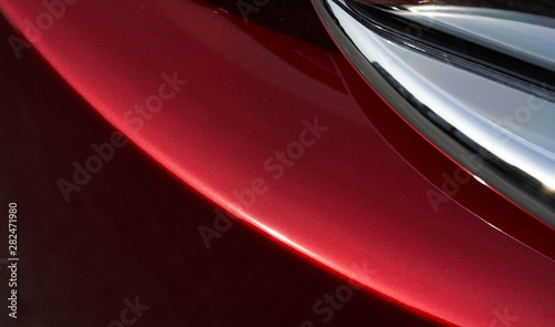 Close up detail of red metallic paint coating car body © jamesteohart