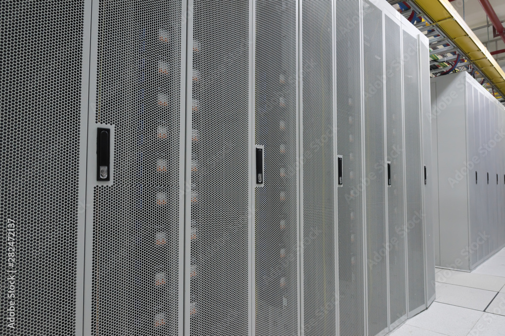 Close-up of a white metal grid cabinet with neatly arranged data centers Close-up of a white metal grid cabinet with neatly arranged data centers