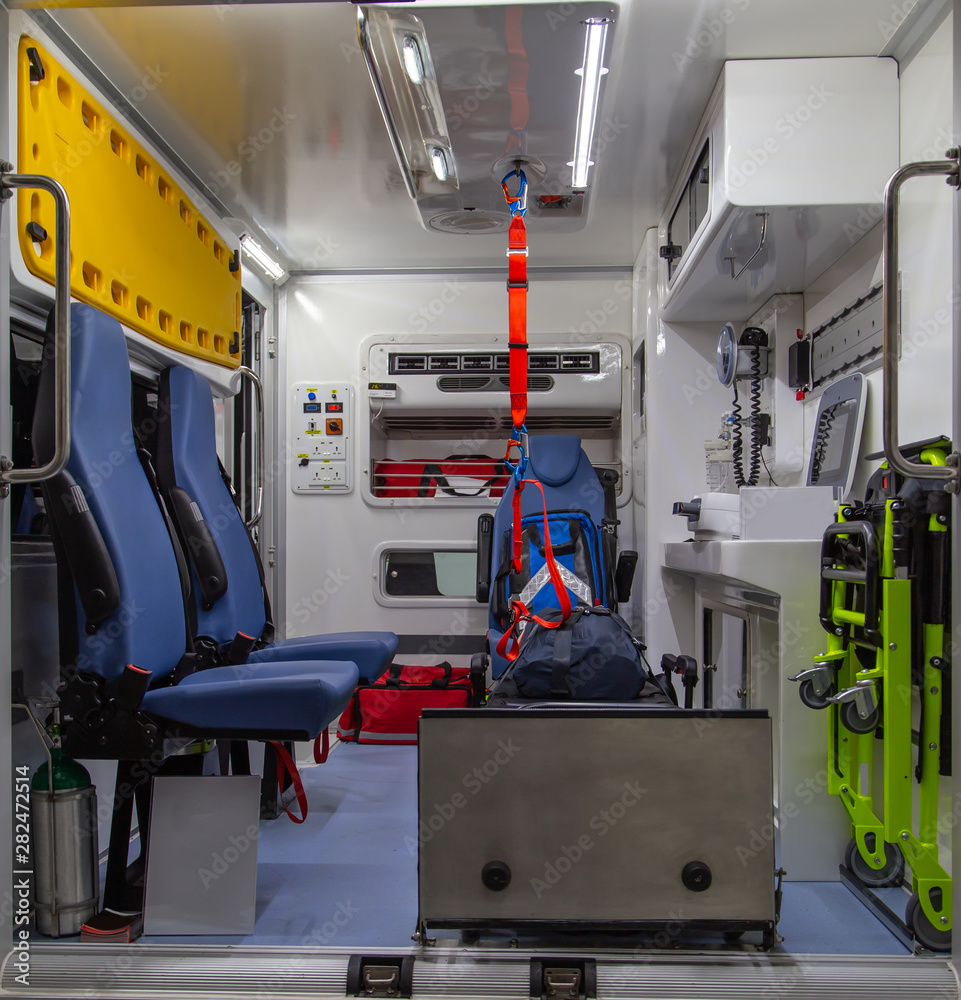 Interior of an ambulance with bed, first aid and patient care equipment for emergency service Interior of an ambulance with bed, first aid and patient care equipment for emergency service