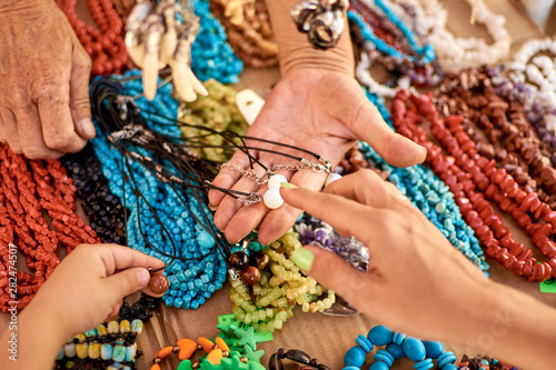 A selection of jewelry in a street shop. Trade in souvenirs, necklaces.