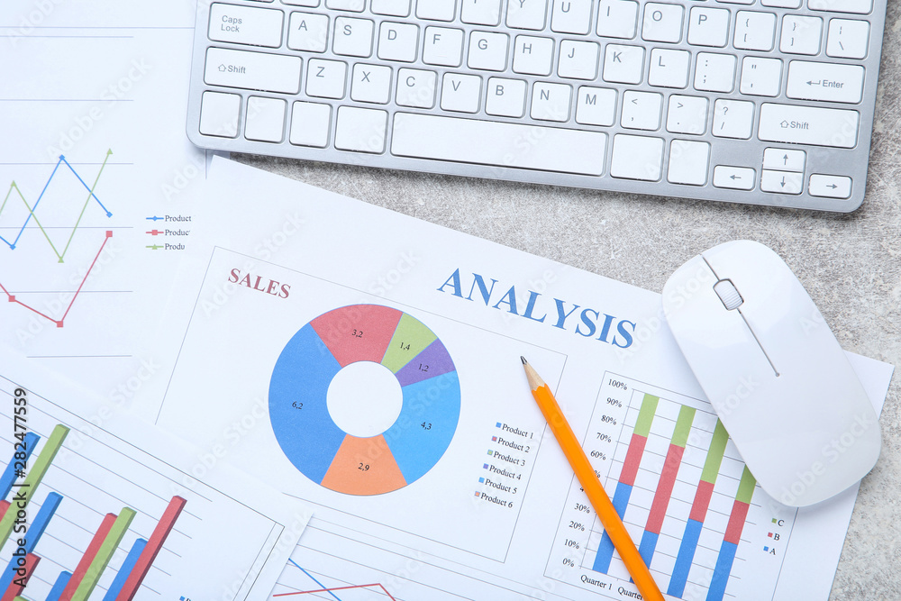 Financial papers with keyboard, mouse and pencil on wooden table Financial papers with keyboard, mouse and pencil on wooden table