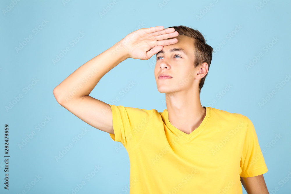 Portrait of young man in yellow t-shirt on blue background Portrait of young man in yellow t-shirt on blue background