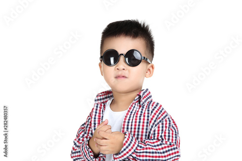 Beautiful boy in fashion clothing and sunglasses on white background