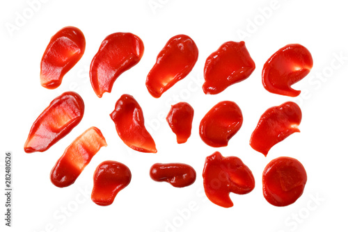 Red sauce splashes isolated on white background. Ketchup.