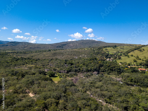 Beautiful aerial view of Serra do Cipo in Minas Gerais with forests and mountains in sunny summer day with blue sky. Landscape of the Brazilian Cerrado, one of the most devastated biomes.