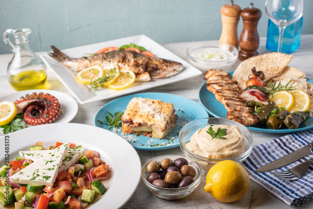 assorted popular greek plates on rustic wooden background assorted popular greek plates on rustic wooden background