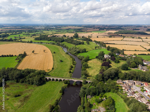 Aerial photo of the the historic Tadcaster Viaduct and River Wharfe located in the West Yorkshire British town of Tadcaster, taken on a bright sunny day photo