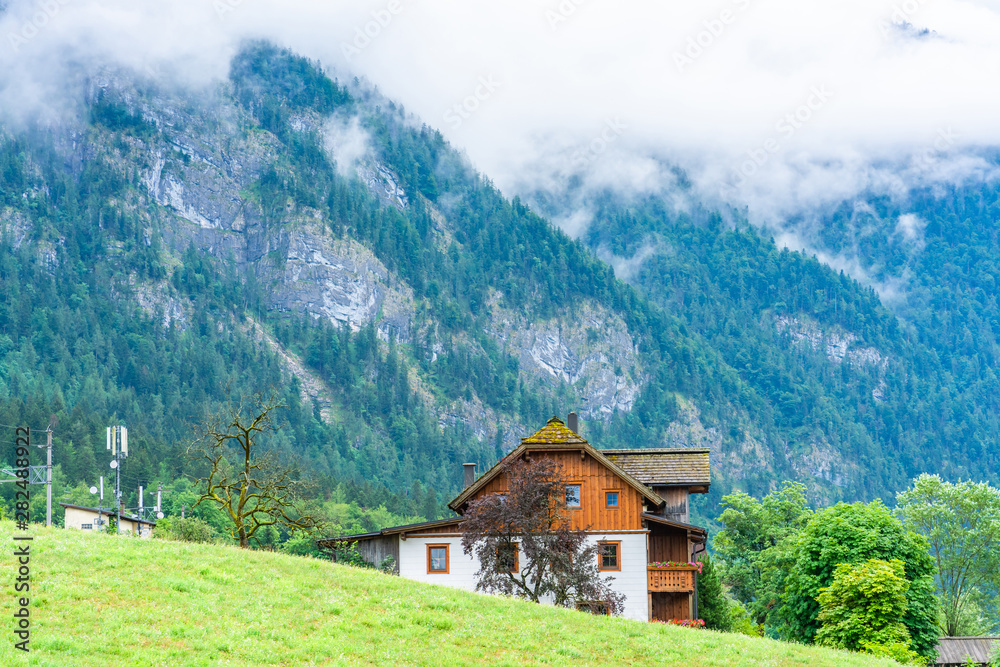 Landscape with traditional house in Salzkammergut, an Austrian region of lakes and Alpine ranges near Salzburg, Austria