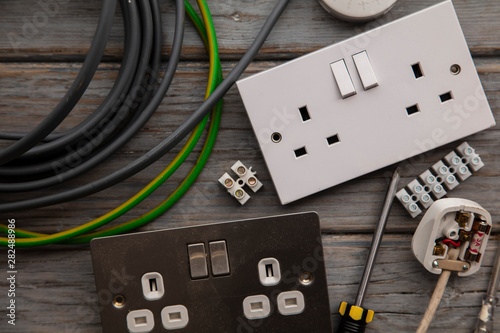 Foto Electrical tools and equipment on a wooden background