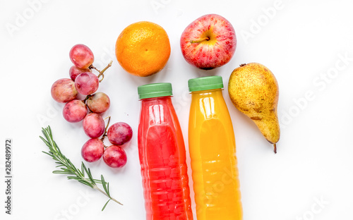 colorful plastic bottle with fruit on white background top view mock up