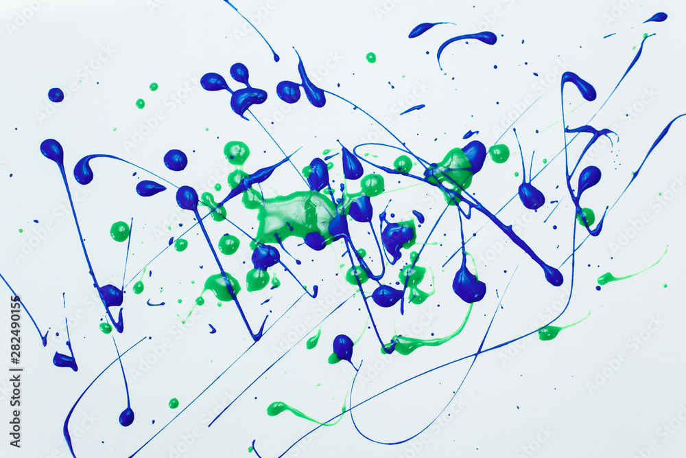 blue and green drops of nail polish on a white background