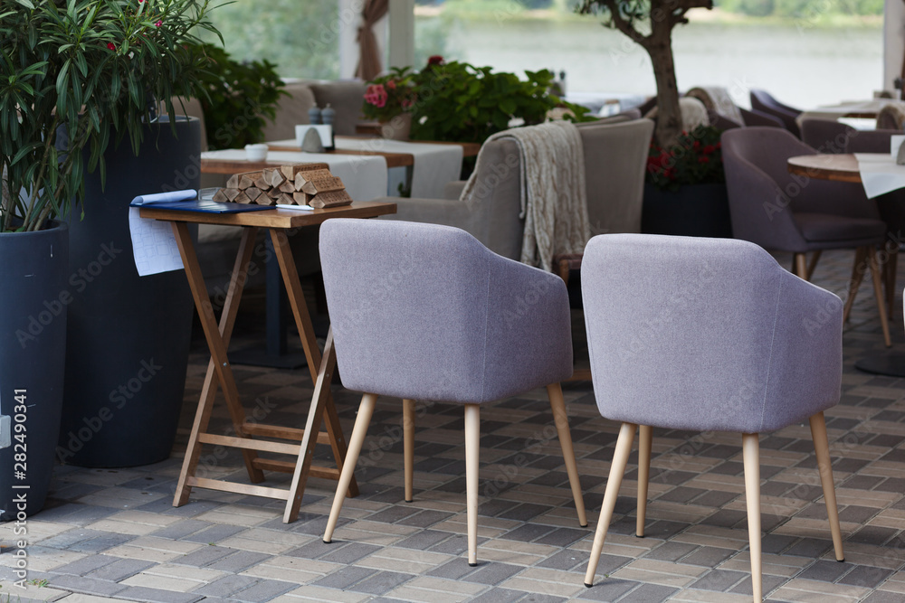 Table and chairs in park cafe. Modern design interior. Concept of vacation and leisure