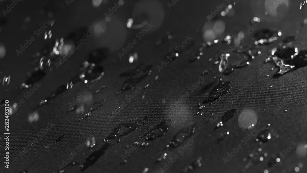 Super slow motion of falling water drops on waterproof cloth texture in detail. Filmed on high speed cinema camera, 1000 fps. Super slow motion of falling water drops on waterproof cloth texture in detail. Filmed on high speed cinema camera, 1000 fps.