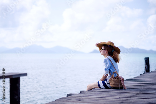 An alone woman sitting on the wood bridge  - Koh mark, Thailand © t.paisit
