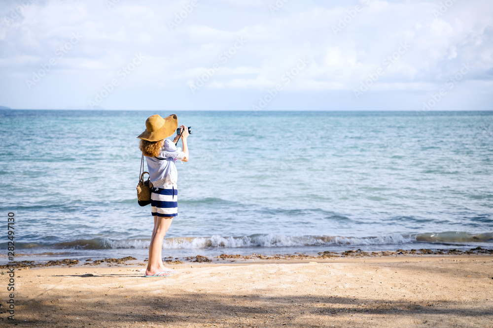 An alone woman taking a photo on the beach, Koh Mark Thailand
