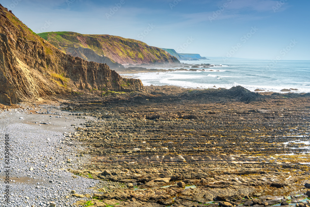 View of Childspit beach near Hartland Quay in North Devon Coast AONB. Copy space in sky.