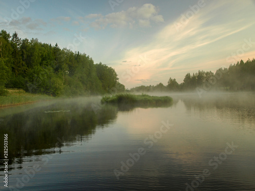 landscape with lake, early morning, mysterious mist rising from the surface of the water