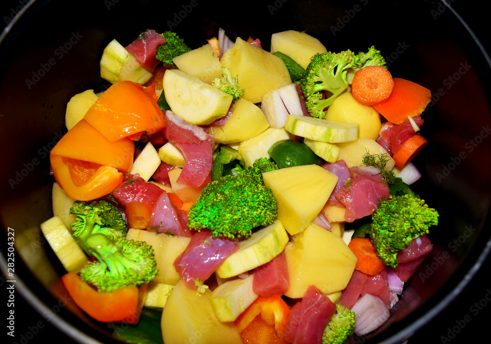 Raw vegetables and beef in a pan ready for cooking Raw vegetables and beef in a pan ready for cooking