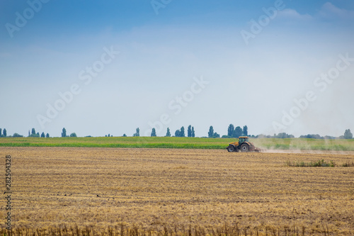 Tractor cultivating the field