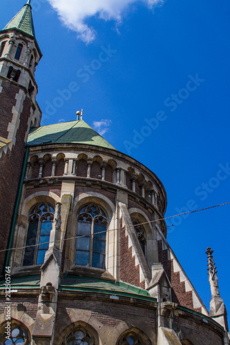 Bottom view of details of the roof of gothic cathedral in Lviv, Ukraine with blue sky on the background