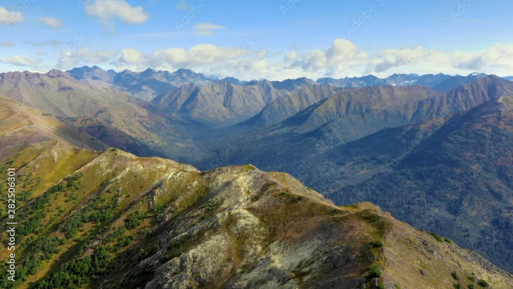 Aerial Forward: Vast Mountains Out To Horizon, With Sunny Tops And Shadow Filled Valleys - Chugach National Forest, Alaska Aerial Forward: Vast Mountains Out To Horizon, With Sunny Tops And Shadow Filled Valleys - Chugach National Forest, Alaska