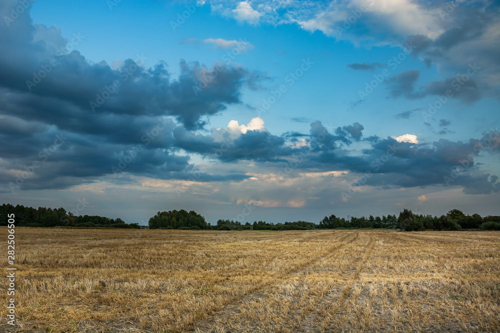 Beautiful and colorful clouds over the stubble