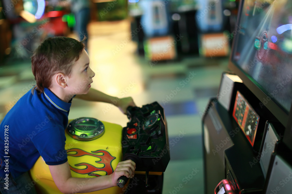 Boy playing motorbike simulator Boy playing motorbike simulator