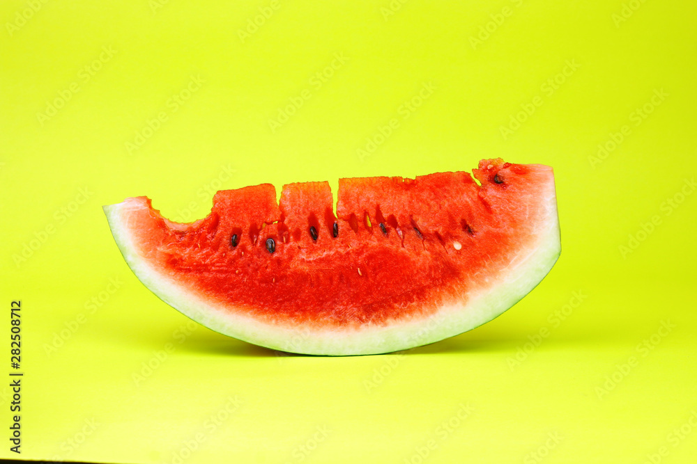 Eaten watermelon slice on yellow background. Summer time fruit. Eaten watermelon slice on yellow background. Summer time fruit.