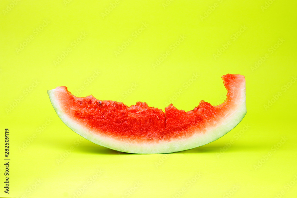 Eaten watermelon slice on yellow background. Summer time fruit. Eaten watermelon slice on yellow background. Summer time fruit.