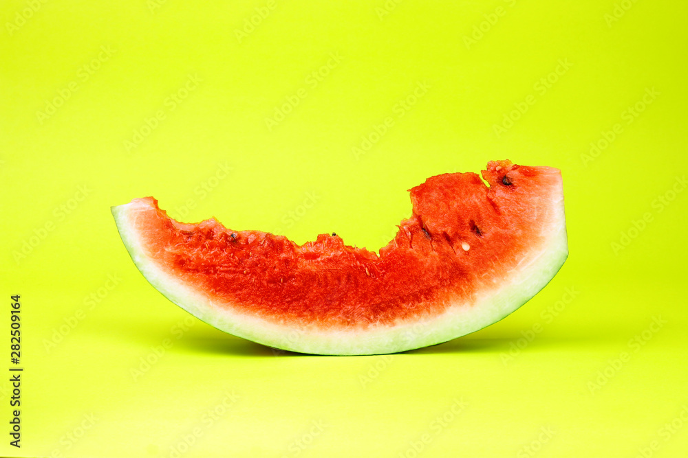 Eaten watermelon slice on yellow background. Summer time fruit. Eaten watermelon slice on yellow background. Summer time fruit.