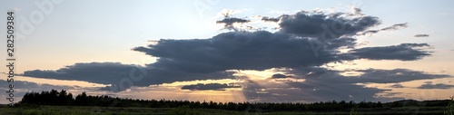 Panorama Sunset - Sun Hiding Behind Dark Clouds Creating God Rays © Ian