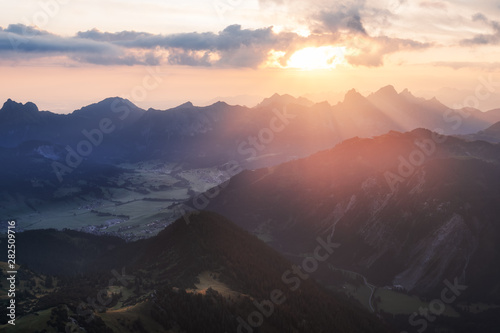 Sunlight bursts through the clouds in the austrian alps in tannheimer tal near vilsalpsee, reutte, tyrol. Valley, From top of the mountain gaishorn