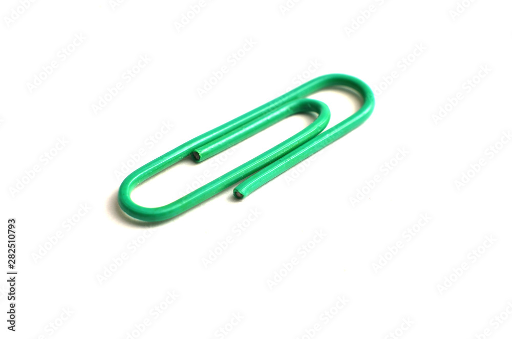 Paper clips, made of iron, are curved in a white background Paper clips, made of iron, are curved in a white background